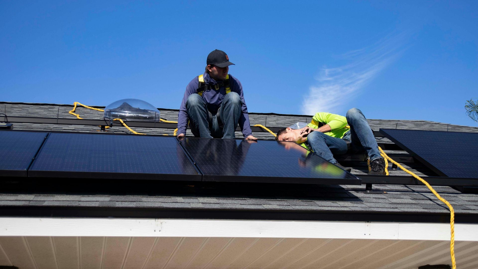 Rogue Solar installers securing Black-on-Black panels on a Virginia roof