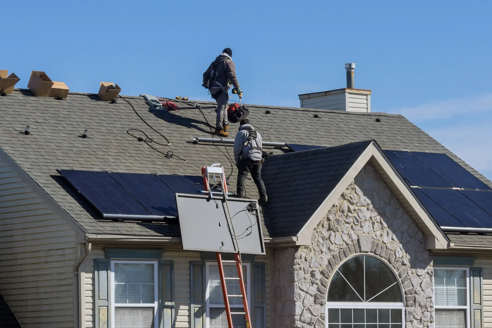 Veteran-led crew installing solar panels on a roof